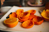 Orange slices and peel on a kitchen cutting board. Photograph by Nenad Stojković, CC BY 2.0.